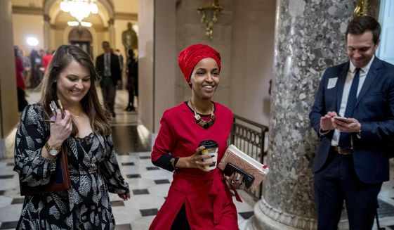 Rep. Ilhan Omar, D-Minn., center, walks through the halls of the Capitol Building in Washington, Wednesday, Jan. 16, 2019. (AP Photo/Andrew Harnik)