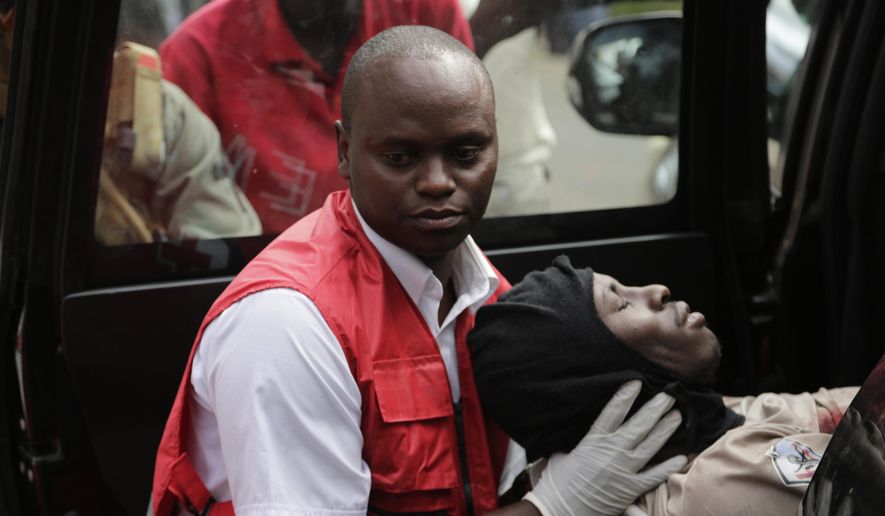 A wounded member of Kenyan special forces is carried from a US embassy diplomatic vehicle into an ambulance by red cross paramedics at the scene Wednesday, Jan. 16, 2019 in Nairobi, Kenya. Extremists stormed a luxury hotel in Kenya&#39;s capital on Tuesday, setting off thunderous explosions and gunning down people at cafe tables in an attack claimed by Africa&#39;s deadliest Islamic militant group (AP Photo/Khalil Senosi)