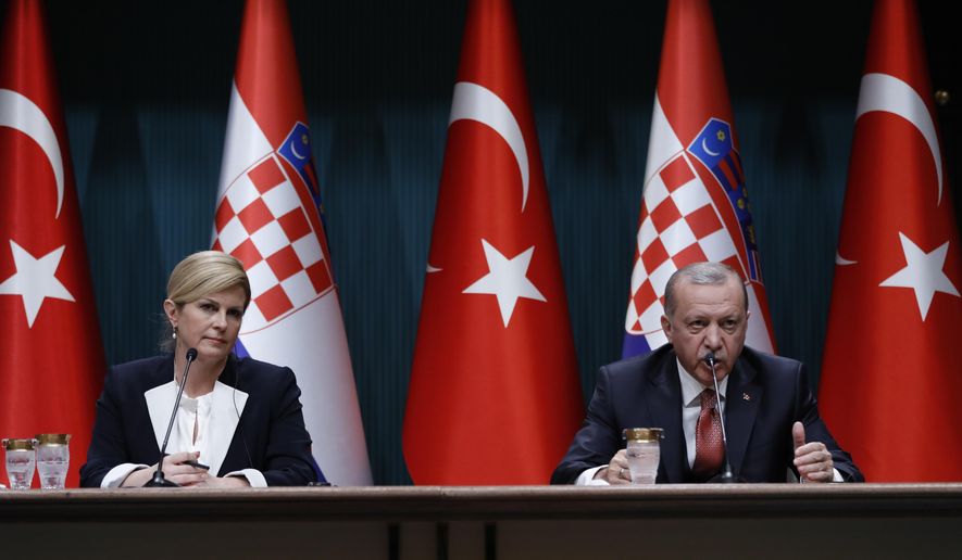 Croatia's President Kolinda Grabar-Kitarovic, left, listens to Turkey's President Recep Tayyip Erdogan, right, during a joint news conference after their meeting at the Presidential Palace in Ankara, Turkey, Wednesday, Jan. 16, 2019. (AP Photo/Burhan Ozbilici)