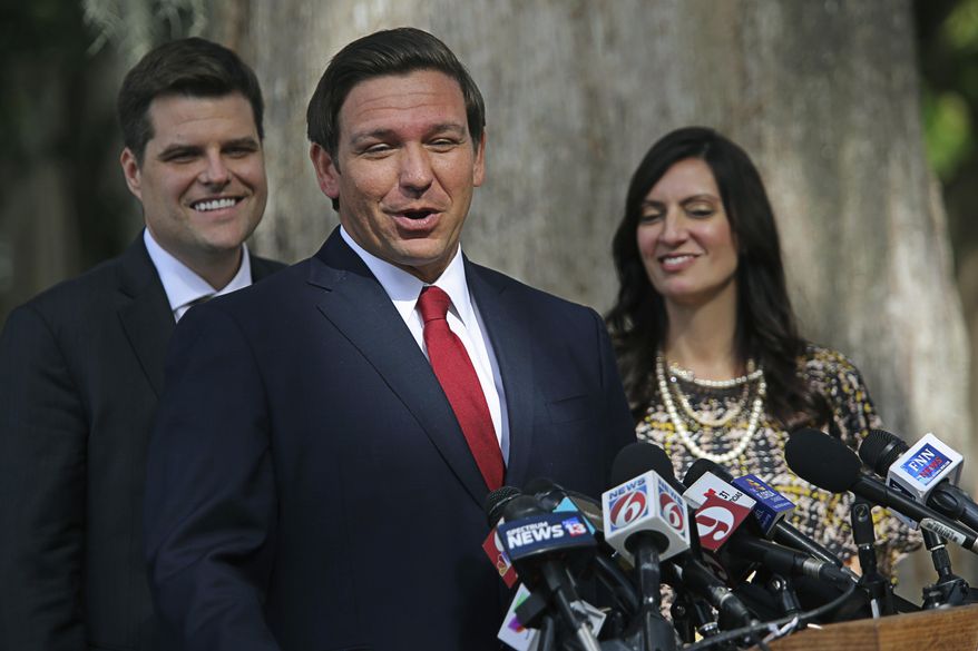 Congressman Matt Gaetz, left, and Lt. Gov. Jeanette Nuñez listen, right, as Florida Gov. Ron DeSantis speaks during a press conference about medical marijuana at Kraft Azalea Park in Winter Park, Fla., on Thursday, Jan. 17, 2019. (Ricardo Ramirez Buxeda/Orlando Sentinel via AP)