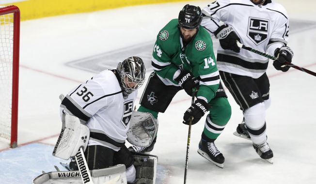 Dallas Stars left wing Jamie Benn (14) tries to score a goal against Los Angeles Kings goaltender Jack Campbell (36) and defenseman Alec Martinez (27) during the third period of an NHL hockey game in Dallas, Thursday, Jan. 17, 2019. The Kings won 2-1 (AP Photo/LM Otero)