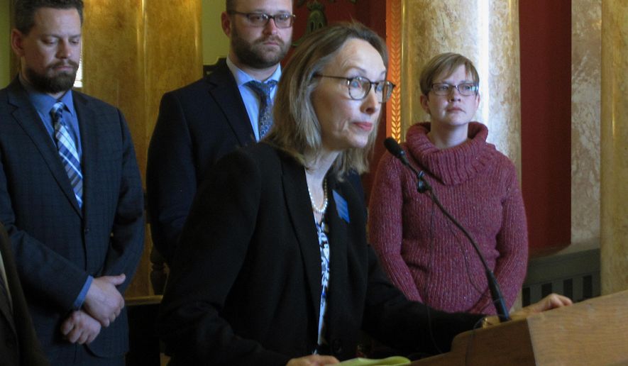 Kristen Newby, right, listens as state Rep. Mary Ann Dunwell takes a question during a news conference on Wednesday, Jan. 16, 2019, in Helena, Mont. Newby, who says she is the daughter of a former Montana high school athletic trainer accused of abusing teenage boys, says she supports a bill that would lift the statute of limitations for sex offenses against children. (AP Photo/Matt Volz)