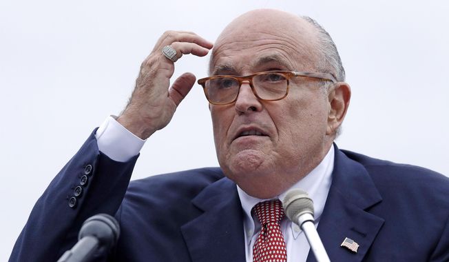 In this Aug. 1, 2018, file photo, Rudy Giuliani, an attorney for President Donald Trump, addresses a gathering during a campaign event in Portsmouth, N.H. Giuliani says he’s never said there was no collusion between Russia and members of the Trump campaign. Giuliani’s comments Wednesday night on CNN directly contradict the position of his own client, who has repeatedly insisted that there was no collusion during his successful 2016 presidential campaign. Giuliani himself has described the idea of Russian collusion as “total fake news.” (AP Photo/Charles Krupa, File )