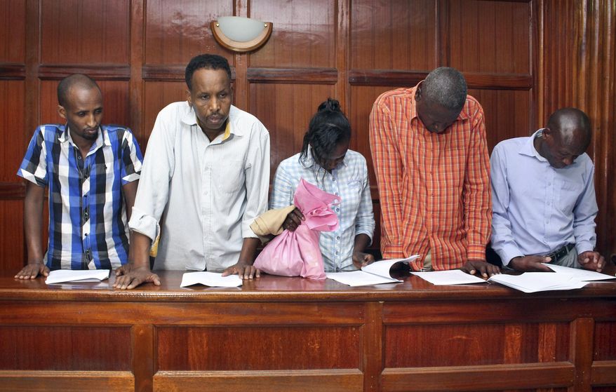 From left to right, suspects Osman Ibrahim, Guleid Abdihakim, Gladys Kaari Justus, Oliver Kanyango Muthee and Joel Nganga Wainaina appear at a hearing at Milimani law courts in Nairobi, Kenya Friday, Jan. 18, 2019. Police who are investigating this week's extremist attack on a Nairobi hotel complex asked the court that the suspects who are accused of involvement in the attack be held for 30 days in order for the police to complete their investigations, which the court granted. (AP Photo)