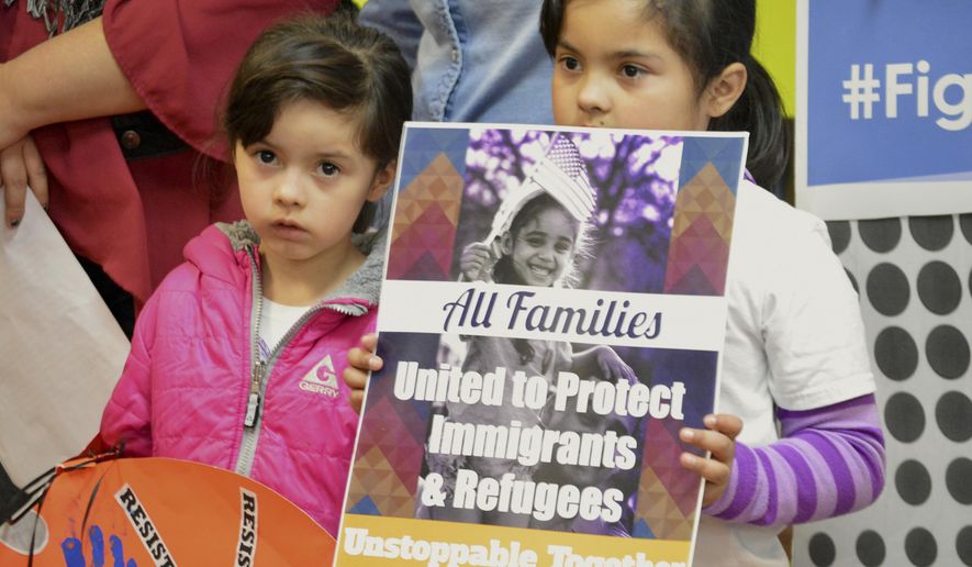 FILE - In this Jan. 25, 2017 file photo, Jocelynn Lujan, left, and her sister, Jennifer, attend a news conference in Albuquerque, N.M., where activists denounced President Donald Trump's executive actions on immigration. Identical Democratic proposals in the New Mexico House and Senate would prevent state agencies from cooperating with federal immigration authorities and limit the authority of sheriffs and jails to hold federal immigrant detainees. (AP Photo/Russell Contreras, File)