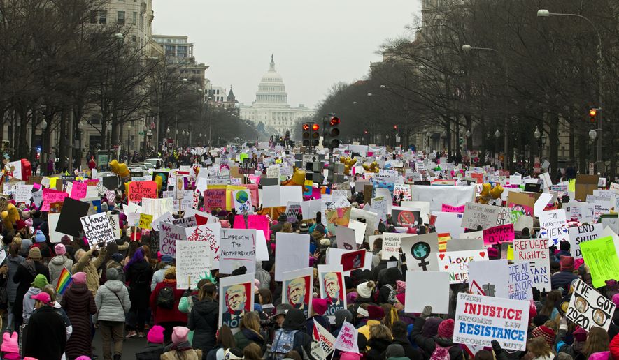 Demonstrators march on Pennsylvania Av. during the Women&#x27;s March in Washington on Saturday, Jan. 19, 2019.  Organizers had originally planned to gather Saturday on the National Mall, but with the forecast calling for snow and freezing rain Saturday and the National Park Service no longer plowing the snow, the march&#x27;s location and route was altered this week to start at Freedom Plaza and march down Pennsylvania Avenue past the Trump International Hotel.  (AP Photo/Jose Luis Magana)