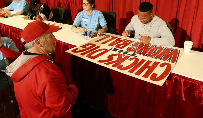 Longtime Cardinal fan &amp;quot;Mr. Sign Guy&amp;quot; Marty Prather, of Springfield, Mo., has St. Louis Cardinals&#x27; Kolten Wong autograph his Wong sign at Cardinals Care Winter Warm-Up on Saturday, Jan. 19, 2019, in St. Louis, Mo. (Laurie Skrivan,/St. Louis Post-Dispatch via AP)