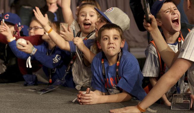 Young fans react as players appear during the Chicago Cubs&#x27; annual fan convention in Chicago on Friday Jan. 18, 2019. (Patrick Kunzer/Daily Herald via AP)