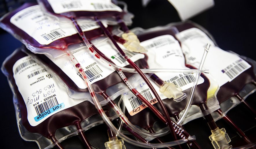 In this Thursday, Jan. 10, 2019 photo, bags of donated blood ready for final labels to be affixed are displayed in LifeServe Blood Center's lab in Des Moine, Iowa. (Kelsey Kremer/The Des Moines Register via AP)