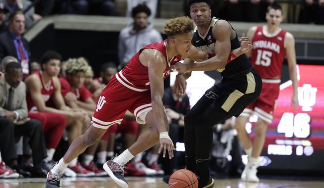 Indiana guard Romeo Langford (0) gets tied up with Purdue guard Nojel Eastern (20) during the second half of an NCAA college basketball game in West Lafayette, Ind., Saturday, Jan. 19, 2019. Purdue defeated Indiana 70-55. (AP Photo/Michael Conroy)