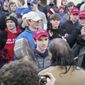 A teenager wearing a &quot;Make America Great Again&quot; hat, center left, stands in front of an elderly Native American singing and playing a drum in Washington, Friday, Jan. 18, 2019. The Roman Catholic Diocese of Covington in Kentucky is looking into this and other videos from a rally in Washington. (Survival Media Agency via AP)