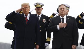 President Donald Trump, left, and Secretary of State Mike Pompeo stand at attention as they await a U.S. Navy carry team moving a transfer case containing the remains of Scott A. Wirtz, Saturday, Jan. 19, 2019, at Dover Air Force Base, Del. According to the Department of Defense, Wirtz, a civilian and former Navy SEAL from St. Louis, Mo., was killed Jan. 16, 2019, in a suicide bomb attack in Manbij, Syria. (AP Photo/Patrick Semansky)