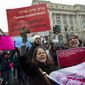 A group hold up signs at freedom plaza during the women&#39;s march in Washington on Saturday, Jan. 19, 2019. (AP Photo/Jose Luis Magana)