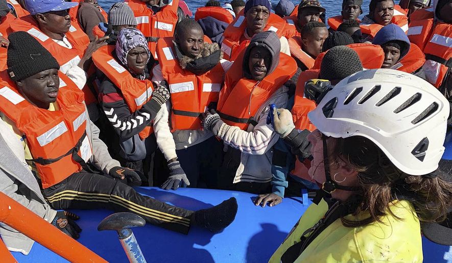 In this photo taken on Saturday, Jan. 19, 2019, rescued migrants are assisted by Sea-Watch rescue ship&#x27;s personnel in the Mediterranean Sea. A private rescue boat with dozens of migrants aboard sought permission for a second day to enter a safe port Sunday, but said so far its queries to several nations haven&#x27;t succeeded. Another vessel crowded with panicking migrants and taking on water, meanwhile, put out an urgent, separate appeal for help in the southern Mediterranean. Sea-Watch 3, run by a German NGO, said Sunday it has contacted Italy, Malta, Libya as well as the Netherlands, since the boat is Dutch-flagged, asking where it can bring the 47 migrants it had taken aboard. Sea-Watch tweeted that Libyan officials had hung up when it asked for a port assignment. (Doug Kuntz/Sea-Watch via AP)
