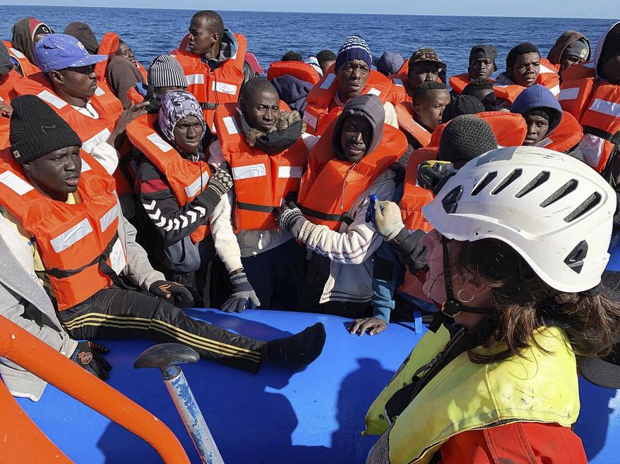In this photo taken on Saturday, Jan. 19, 2019, rescued migrants are assisted by Sea-Watch rescue ship's personnel in the Mediterranean Sea. A private rescue boat with dozens of migrants aboard sought permission for a second day to enter a safe port Sunday, but said so far its queries to several nations haven't succeeded. Another vessel crowded with panicking migrants and taking on water, meanwhile, put out an urgent, separate appeal for help in the southern Mediterranean. Sea-Watch 3, run by a German NGO, said Sunday it has contacted Italy, Malta, Libya as well as the Netherlands, since the boat is Dutch-flagged, asking where it can bring the 47 migrants it had taken aboard. Sea-Watch tweeted that Libyan officials had hung up when it asked for a port assignment. (Doug Kuntz/Sea-Watch via AP)