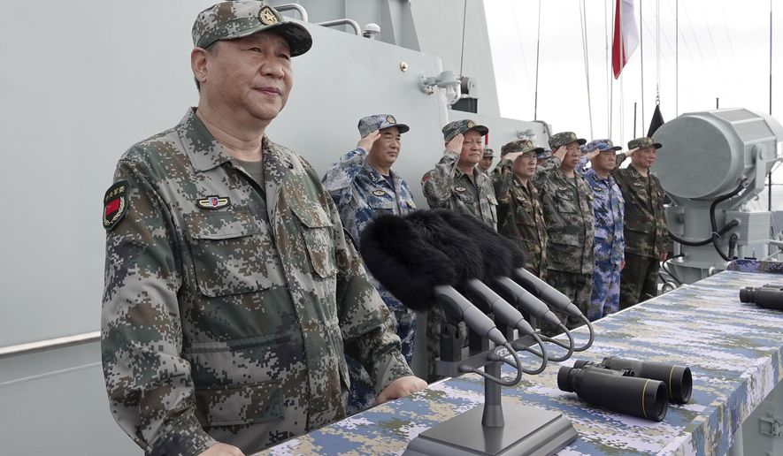 FILE - In this April 12, 2018, file photo released by Xinhua News Agency, Chinese President Xi Jinping speaks after reviewing the Chinese People&#39;s Liberation Army (PLA) Navy fleet in the South China Sea. A new Pentagon report lays out U.S. concerns about China&#39;s growing military might, underscoring worries about a possible attack against Taiwan. The report&#39;s release on Jan. 15, 2019 came just a week after Chinese President Xi Jinping called on his People&#39;s Liberation Army to better prepare for combat. (Li Gang/Xinhua via AP, File)