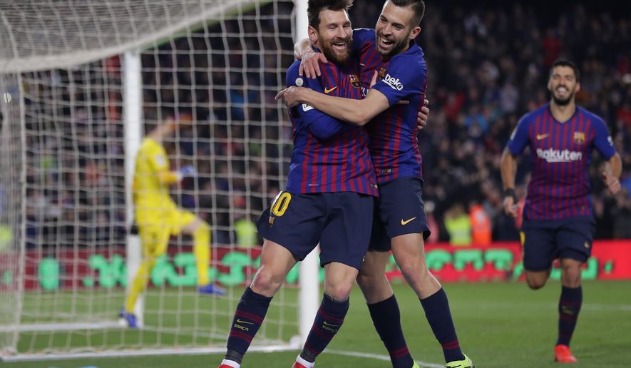 FC Barcelona's Lionel Messi, left, celebrates with his teammate Jordi Alba after scoring during the Spanish La Liga soccer match between FC Barcelona and Leganes at the Camp Nou stadium in Barcelona, Spain, Sunday, Jan. 20, 2019. (AP Photo/Manu Fernandez)