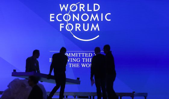 People set up the main stage at the congress center where the annual meeting of the World Economic Forum 2019, WEF, take place in Davos, Sunday, Jan. 20, 2019. (AP Photo/Markus Schreiber)