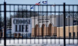Flags fly over the Covington Catholic High School stadium in Park Kills, Ky., Sunday, Jan 20, 2019. A diocese in Kentucky has apologized after videos emerged showing students from the Catholic boys&#39; high school mocking Native Americans outside the Lincoln Memorial on Friday after a rally in Washington. (AP Photo/Bryan Woolston)