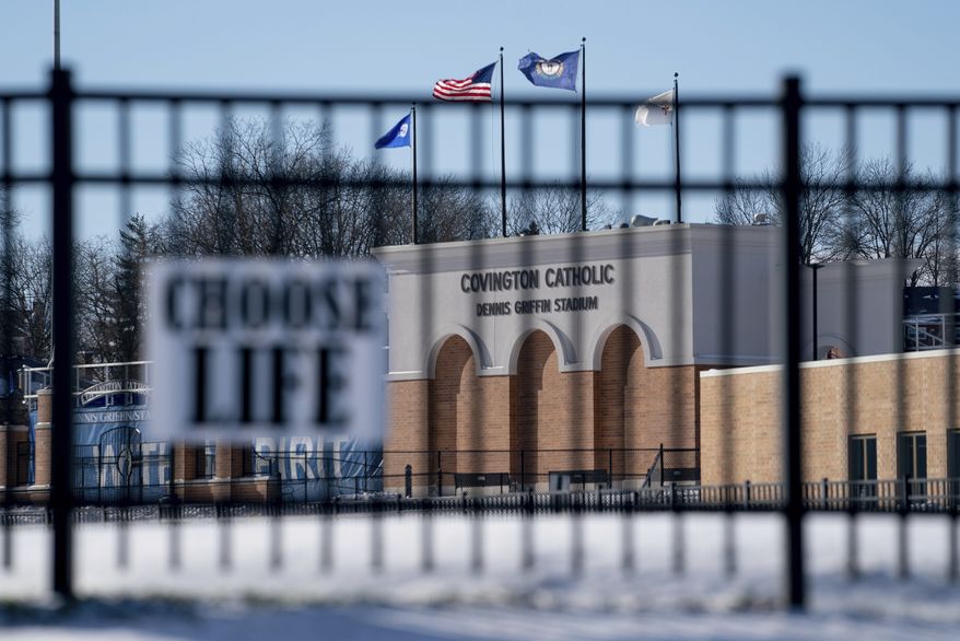 Flags fly over the Covington Catholic High School stadium in Park Kills, Ky., Sunday, Jan 20, 2019. A diocese in Kentucky has apologized after videos emerged showing students from the Catholic boys&#x27; high school mocking Native Americans outside the Lincoln Memorial on Friday after a rally in Washington. (AP Photo/Bryan Woolston)
