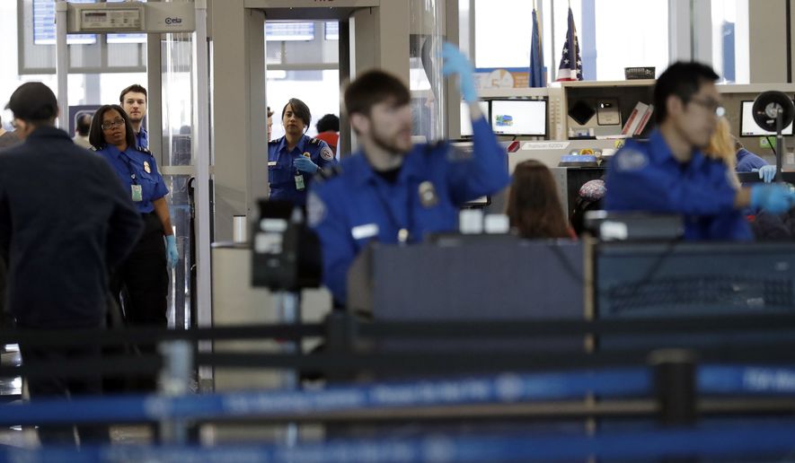 FILE- In this Jan. 5, 2019, file photo Transportation Security Administration officers work at a checkpoint at O'Hare airport in Chicago. The percentage of TSA airport screeners missing work has hit 10 percent as the partial government shutdown stretches into its fifth week. The Transportation Security Administration said Monday, Jan. 21, that Sunday’s absence rate compared to 3.1 percent on the comparable Sunday a year ago. (AP Photo/Nam Y. Huh, File)