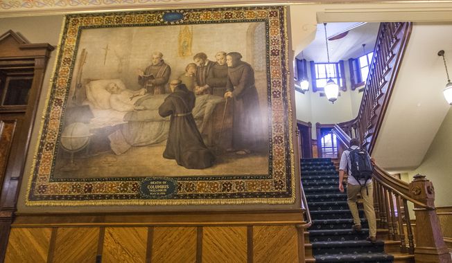 This Nov. 29, 2017, photo shows a mural of Christopher Columbus at Notre Dame in South Bend, Ind. The University of Notre Dame will cover murals in a campus building that depict Christopher Columbus in America, the school&#x27;s president said, following criticism that the images depict Native Americans in stereotypical submissive poses before white European explorers. (Robert Franklin/South Bend Tribune via AP)