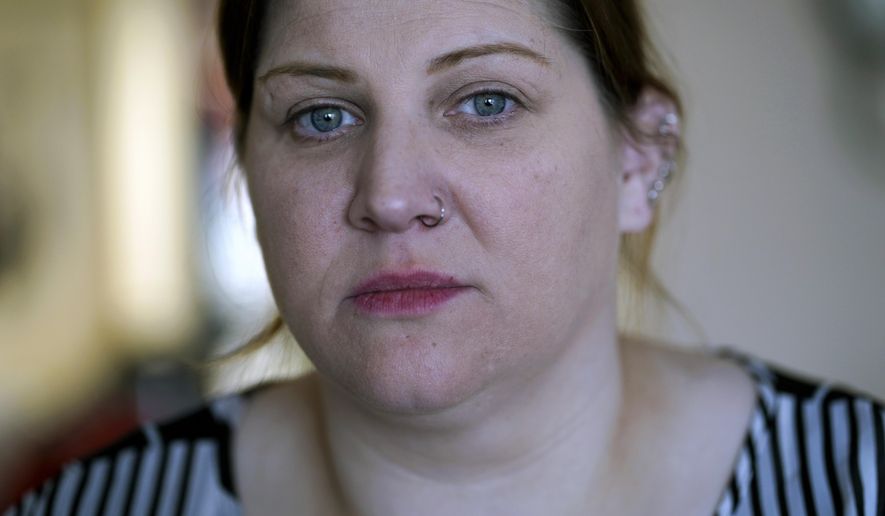 Doris Cochran poses for a portrait in her apartment in Arlington, Va., on Friday, Jan. 18, 2019. Cochran is a disabled mother of two young boys living in subsidized housing in Arlington, Virginia. She’s stockpiling canned foods to try to make sure her family won’t go hungry if her food stamps run out. She says she just doesn’t know “what’s going to happen” and that’s what scares her the most. (AP Photo/Sait Serkan Gurbuz)