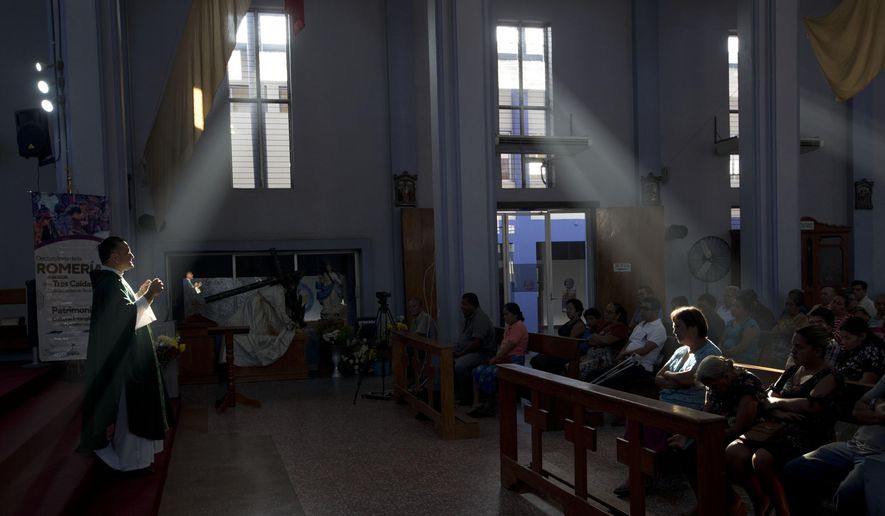 Fernando Cuevas, of the Scalabrinian Missionaries, celebrates Mass at a Catholic church in Tecun Uman, Guatemala, on the border with Mexico, Sunday, Jan. 20, 2019. Scalabrinians were among the first to start ministering to migrants in the Americas, where little by little, a network of safe houses tied to the church sprang up in Mexico, El Salvador, Guatemala and Honduras, according to Bishop Raul Vera of Saltillo in northern Mexico, one of the first Mexicans to get involved in the cause. (AP Photo/Moises Castillo)