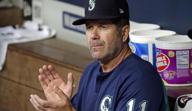 FILE - In this Aug. 10, 2017, file photo, Seattle Mariners hitting coach Edgar Martinez applauds in the dugout before a baseball game against the Los Angeles Angels in Seattle. Martinez, Mariano Rivera and Roy Halladay seem likely to be elected to baseball’s Hall of Fame on Tuesday, Jan. 22, 2019. (AP Photo/Elaine Thompson)