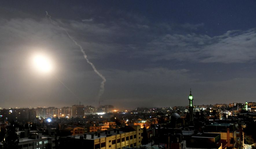 This photo released by the Syrian official news agency SANA, shows missiles flying into the sky near international airport, in Damascus, Syria, Monday, Jan. 21, 2019. In a very unusual move, the Israeli military has issued a statement saying it is attacking Iranian military targets in Syria. It is also warning Syrian authorities not to retaliate against Israel. (SANA via AP)
