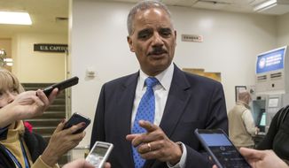Former Attorney General Eric Holder takes questions from reporters at the Capitol where he attended the swearing-in of Sen. Doug Jones, D-Ala., in Washington, Wednesday, Jan. 3, 2018. Holder says he is &quot;deeply disturbed&quot; that Attorney General Jeff Sessions hasn&#39;t spoken out to defend his employees at the Justice Department amid Republican criticism of the FBI. (AP Photo/J. Scott Applewhite)