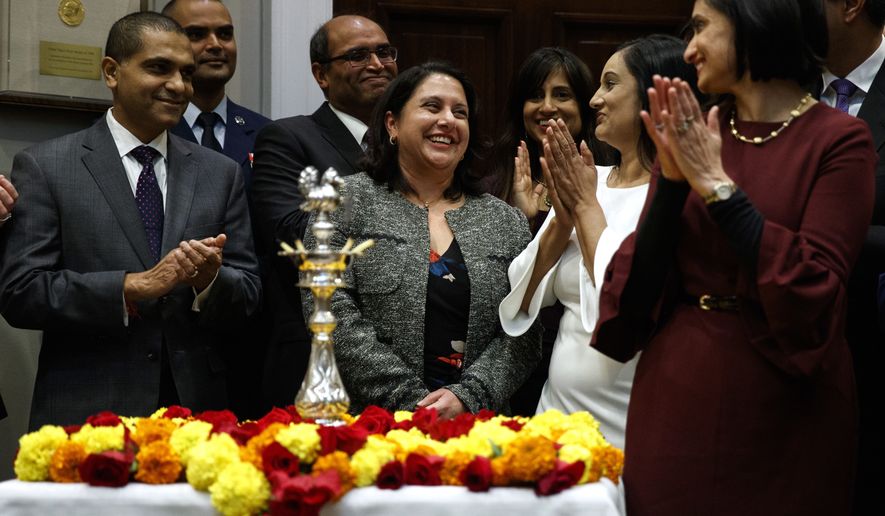 Neomi Rao, administrator of the Office of Information and Regulatory Affairs, smiles as President Donald Trump announces his intention to nominate her to fill Brett Kavanaugh&#x27;s seat on the U.S. Court of Appeals for the D.C. Circuit, during a Diwali ceremonial lighting of the Diya in the Roosevelt Room of the White House, Tuesday, Nov. 13, 2018, in Washington. (AP Photo/Evan Vucci) **FILE**