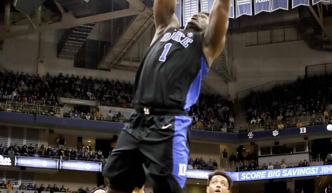 Duke&#x27;s Zion Williamson (1) goes up for during a dunk in front of Pittsburgh&#x27;s Terrell Brown (21) during the first half of an NCAA college basketball game, Tuesday, Jan. 22, 2019, in Pittsburgh. (AP Photo/Keith Srakocic)