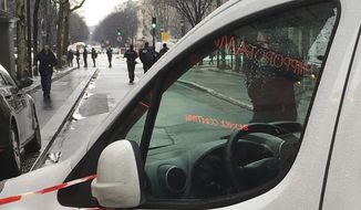 Police forces cordon off the area after a bank robbery in Paris, Tuesday, Jan.22, 2019. Paris police said several suspects were on the run after they robbed a Champs-Elysees Milleis (formely Barclays) bank on day light near the luxury shops of the famed touristic avenue. (AP Photo/Elaine Ganley)