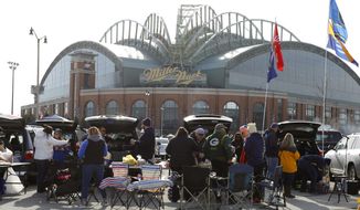 FILE - In this April 2, 2018, file photo, fans tailgate in the parking lot of Miller Park before a home opener baseball game between the Milwaukee Brewers and St. Louis Cardinals, in Milwaukee. The Brewers&#39; home ballpark will be renamed when MillerCoors&#39; naming rights expire following the 2020 season. MillerCoors said in a statement Tuesday, Jan. 22, 2019, the rights to Miller Park will go to American Family Insurance beginning in 2021. (AP Photo/Jeffrey Phelps)