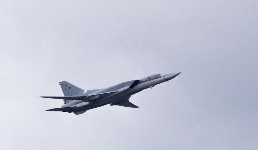 FILE - In this Thursday, May 5, 2016 file photo, a Russian Tu-22 bomber flies over Moscow's Kremlin during a general rehearsal for the Victory Day military parade which will take place at Moscow's Red Square on May 9 to celebrate 71 years after the victory in WWII in Moscow, Russia. The Russian military says that one of its long-range bombers has crash-landed in the Arctic, Tuesday Jan. 22, 2019, killing two of its crew of four. (AP Photo/Ivan Sekretarev, File)
