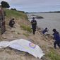 In this photo dated Thursday, Dec, 27, 2018, Thai rescuers cover a body on the shore of the Mekong River in Nakhon Phanom province northeast of Bangkok, Thailand.  DNA tests show that two bodies found washed up on the shore of Thailand&#39;s Mekong River are the corpses of anti-government activists, police said Tuesday, Jan. 22, 2019, in what are feared to be political killings. The two, known by the pseudonyms Puchana and Kasalong, were among three exiled activists who disappeared in December from homes in Laos, where they took shelter after fleeing Thailand. (AP Photo)