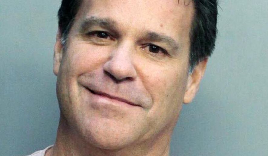 This Jan. 21, 2019 photo released by the Miami Dade County Department of Corrections shows the booking mug of Mark Allen Bartlett who was charged with a weapons violation after a traffic confrontation in Miami. Prosecutors are investigating the confrontation as a possible hate crime. State Attorney Katherine Fernandez Rundle said in a news release, Tuesday, that she has ordered her hate crimes chief to look into the confrontation. (Miami Dade Department of Corrections via AP)