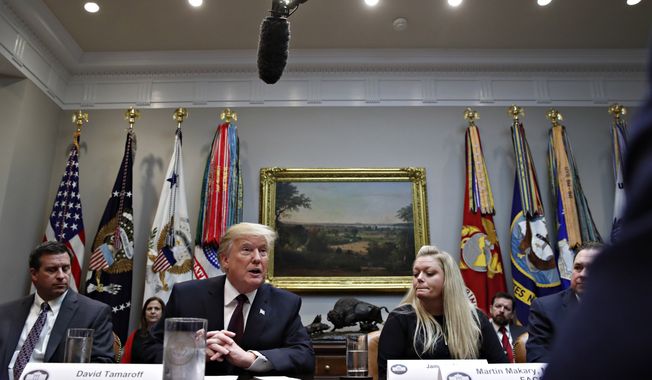 President Donald Trump speaks during a healthcare roundtable in the Roosevelt Room of the White House, Wednesday, Jan. 23, 2019, in Washington. At left of the president is David Silverstein, of Denver, and right is Jamesia Shutt, of Aurora, Colo. (AP Photo/Jacquelyn Martin)