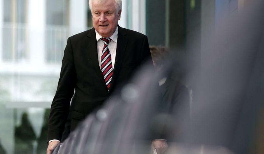 German Interior Minister Horst Seehofer arrives for the presentation of the 'Migration Report 2016/17 'during a press conference in in Berlin, Germany, Wednesday, Jan. 23, 2019. (AP Photo/Michael Sohn)