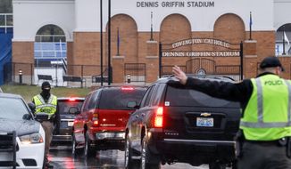 Students arrive at Covington Catholic High School as classes resume following a closing due to security concerns the previous day, Wednesday, Jan. 23, 2019, in Park Hills, Ky. Local police authorities controlled access to the property at entrances and exits. (AP Photo/John Minchillo)