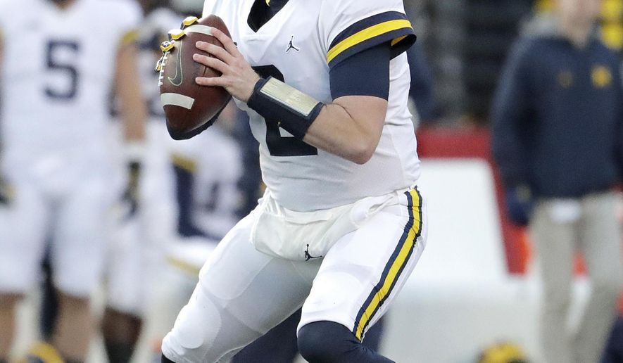 FILE - In this Nov. 10, 2018, file photo, Michigan quarterback Shea Patterson looks to pass against Rutgers during the first half of an NCAA college football game, in Piscataway, N.J. The NCAA quietly made a big change last year that helped quarterback Shea Patterson play for Michigan and will determine whether Justin Fields is eligible this fall at Ohio State.(AP Photo/Julio Cortez, File)