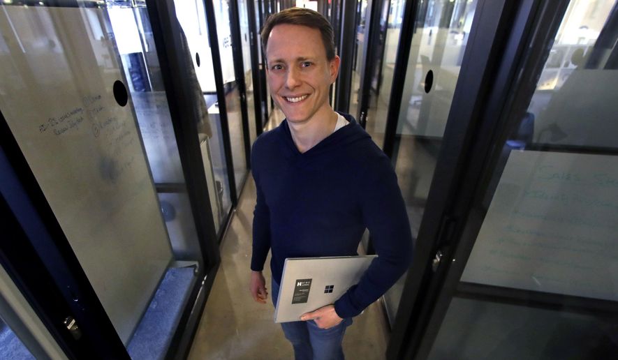 In this Jan. 15, 2019, photo Chris Richardson CEO of Talent Response, a website that helps small businesses find freelancers, poses for a photo in Boston. (AP Photo/Charles Krupa)