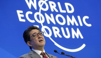 Japanese Prime Minister Shinzo Abe addresses the annual meeting of the World Economic Forum in Davos, Switzerland, Wednesday, Jan. 23, 2019. (AP Photo/Markus Schreiber)