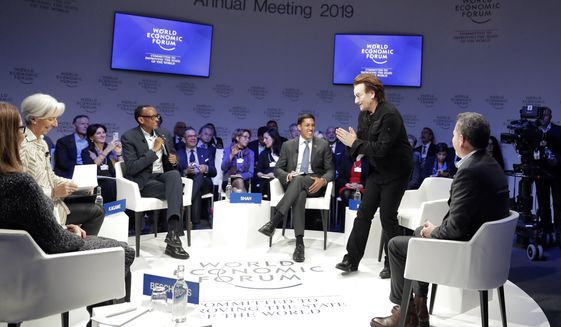 Singer and co-founder of RED Bono, 2nd right, gestures to Afsaneh Mashayekhi Beschloss, founder of RockCreek, Christine Lagarde, Managing Director of IMF and Rwanda President Paul Kagame, from left, as he arrives for the &amp;quot;Closing the Financing Gap&amp;quot; session at the annual meeting of the World Economic Forum in Davos, Switzerland, Wednesday, Jan. 23, 2019. (AP Photo/Markus Schreiber)
