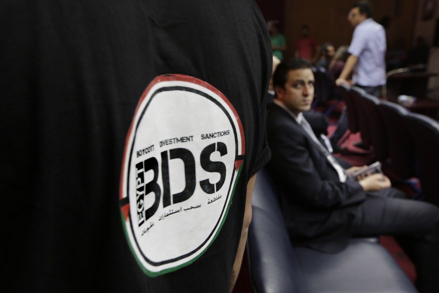 In this Monday, April 20, 2015, photo, an Egyptian wears a T-shirt with a logo of BDS (boycott, divestment and sanctions), a campaign started by Palestinian activists to boycott Israel and Israeli-made goods, during the launch of its campaign at the Egyptian Journalists' Syndicate in Cairo, Egypt. The group calls for a global boycott campaign against Israel as a nonviolent method to promote the Palestinian struggle for independence. (AP Photo/Amr Nabil) **FILE**