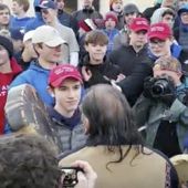 In this Friday, Jan. 18, 2019, file image made from video provided by the Survival Media Agency, Nick Sandmann, wearing a &quot;Make America Great Again&quot; hat, center left, stands in front of Native American elder Nathan Phillips. (Survival Media Agency via AP) ** FILE **