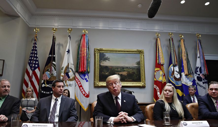President Donald Trump, center, reacts as he is told by a reporter that House Speaker Nancy Pelosi of Calif., said the Democratically controlled House won't pass the required measure for him to make the State of the Union address at the Capitol until after the government is fully opened, during a healthcare roundtable in the Roosevelt Room of the White House, Wednesday, Jan. 23, 2019, in Washington. With the president are David Silverstein, of Denver, left, and Jamesia Shutt, of Aurora, Colo., right. (AP Photo/Jacquelyn Martin)