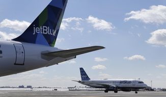 FILE- In this March 16, 2017, file photo, Jet Blue airplanes on the tarmac at John F. Kennedy International Airport in New York. JetBlue Airways Corp. reports financial results Thursday, Jan. 24, 2019. (AP Photo/Seth Wenig, File)