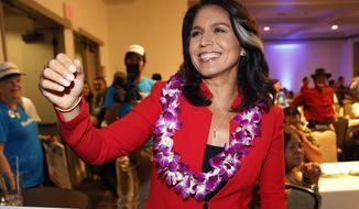 FILE - In this Nov. 6, 2018, file photo, Rep. Tulsi Gabbard, D-Hawaii, greets supporters in Honolulu. The 2020 presidential election already includes more than a half-dozen Democrats whose identities reflect the nation’s growing diversity, as well as embody the coalition that helped Barack Obama first seize the White House in 2008 (AP Photo/Marco Garcia, File)